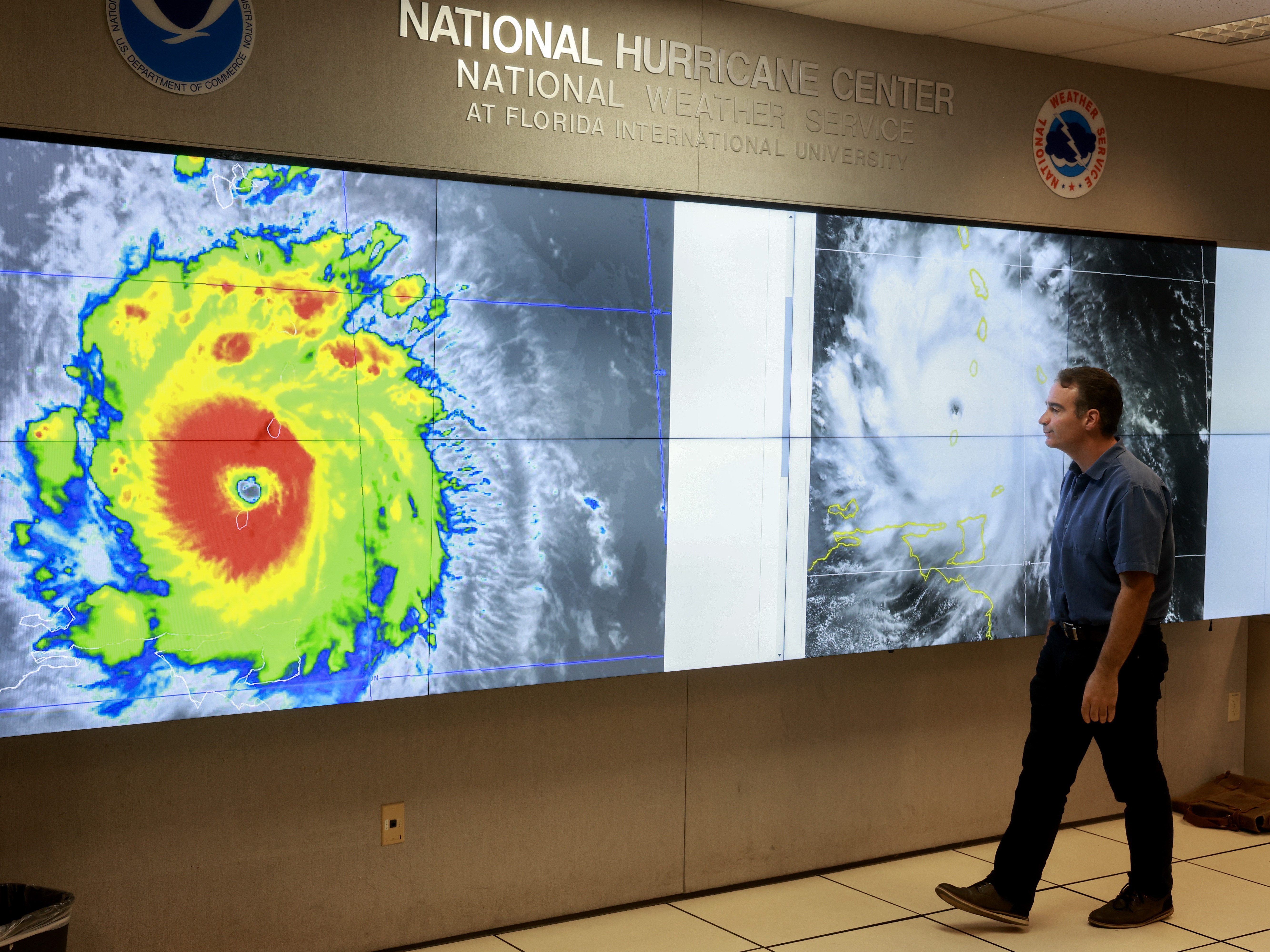 caption: A hurricane specialist looks at a satellite image of Hurricane Beryl, the first hurricane of the 2024 season. The National Hurricane Center provides forecasts of major storms, many of which make landfall in the U.S.. The Center is part of NOAA, the country's oceans- and atmosphere-focused agency. Experts say ongoing staff cuts at the agency could endanger some of its core missions, like forecasting weather.