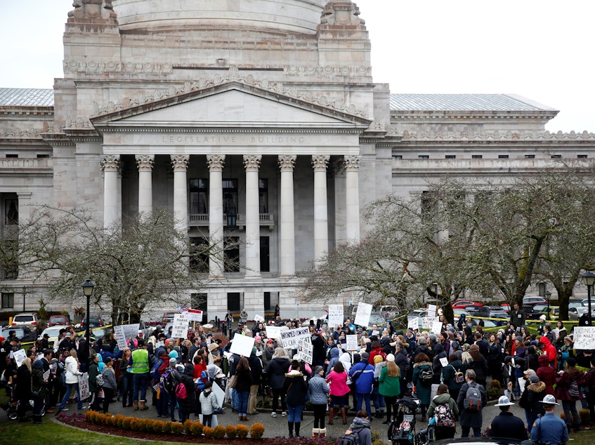 caption: The Washington state Senate passed a bill on Wednesday that would remove the personal belief exemption from the required vaccinations for measles, mumps and rubella. Here, people protest the related house bill outside Washington's Legislative Building in Olympia in February.