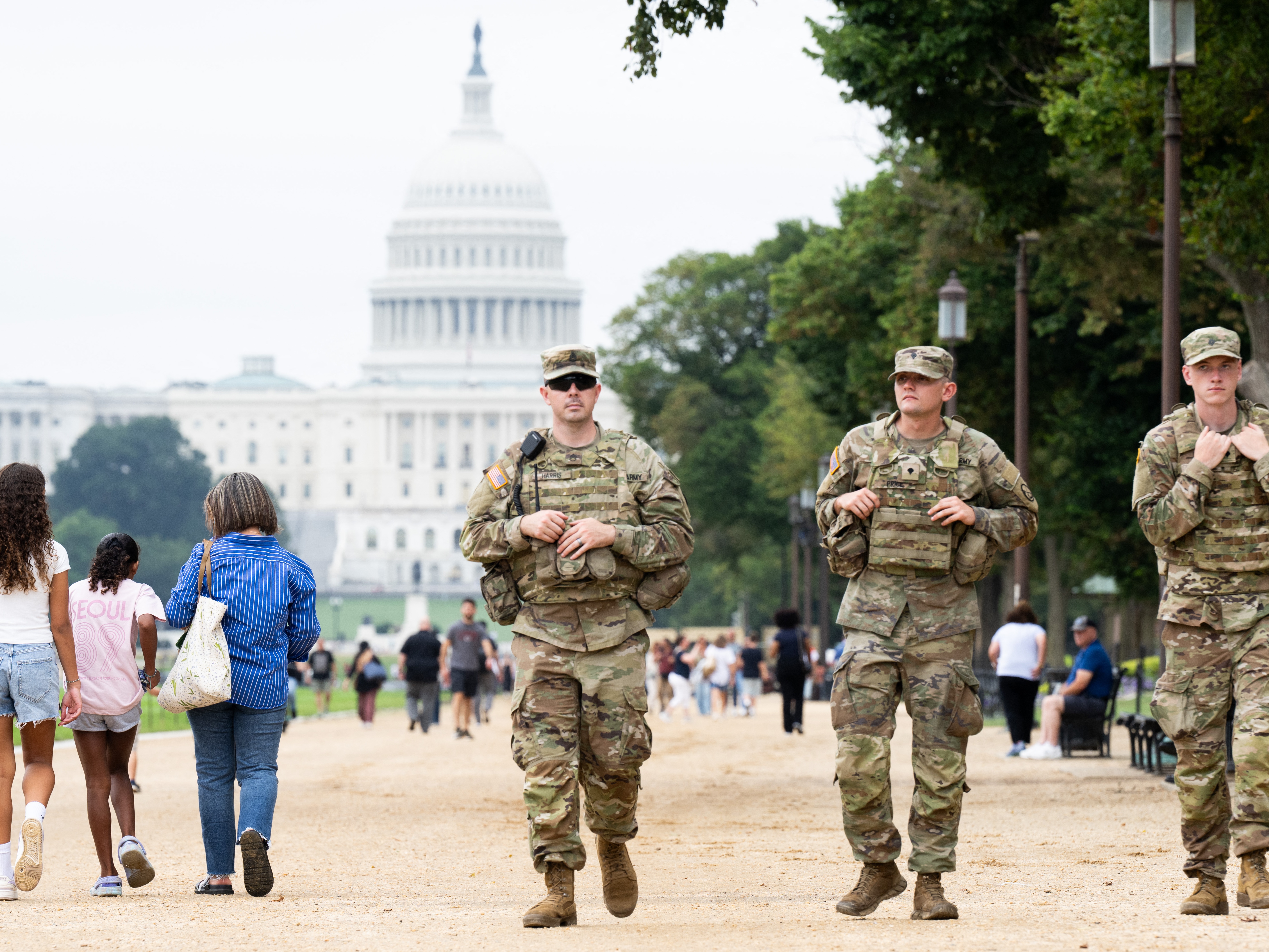 caption: Members of the National Guard patrol on the National Mall near the U.S. Capitol in Washington, D.C., on Wednesday.