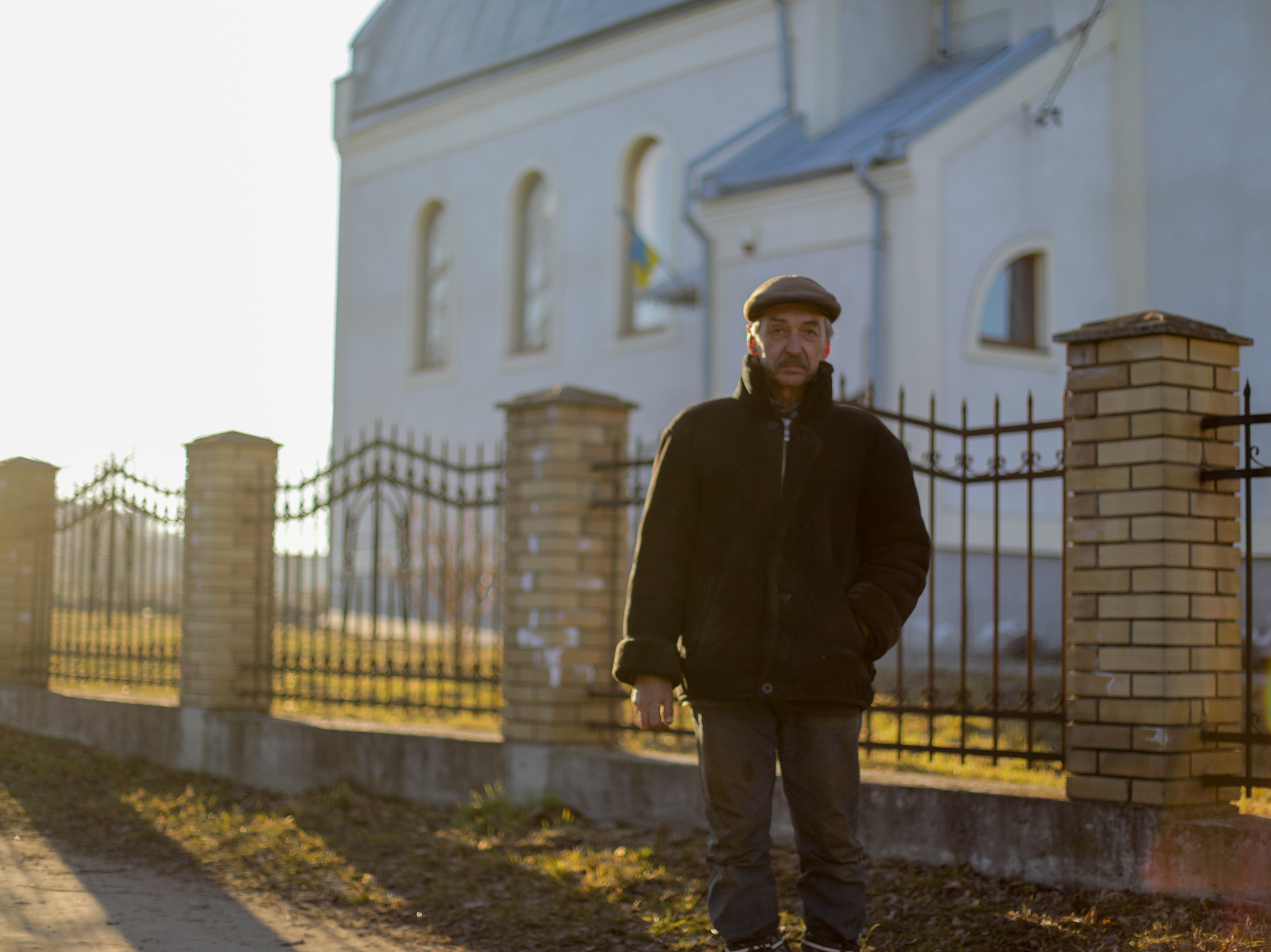 caption: Bohdan Kulik, 62, built the outpost's stove. He is "the village Elon Musk," according to his friends.