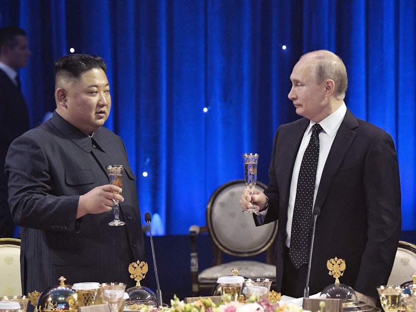 caption: Russian President Vladimir Putin (right) toasts with North Korea's leader Kim Jong Un after their talks in Vladivostok, Russia, on Thursday.