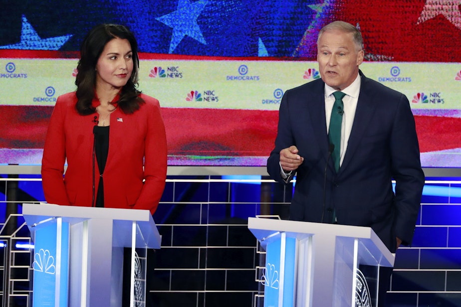 caption: Washington Gov. Jay Inslee speaks during a Democratic primary debate in Miami on Wednesda as Rep. Tulsi Gabbard, D-Hawaii. 