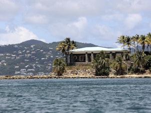 caption: A view of Jeffrey Epstein's stone mansion on Little St. James Island. Prosecutors in the Virgin Islands on Tuesday filed a civil lawsuit that accuses Epstein of human trafficking that victimized young women and children as young as 11 years old. Some of the alleged activity happened as recent as 2018.