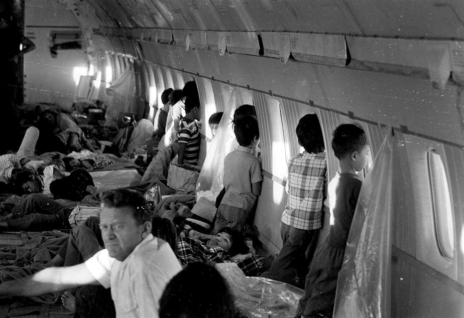 caption: Children aboard this World Airways DC-8 jet were evacuated from Vietnam on April 2, 1975, shortly before the fall of Saigon and two days before the first official Operation Babylift flight. One child was Thanh Jeff Ghar (center, lying by a window), 12.