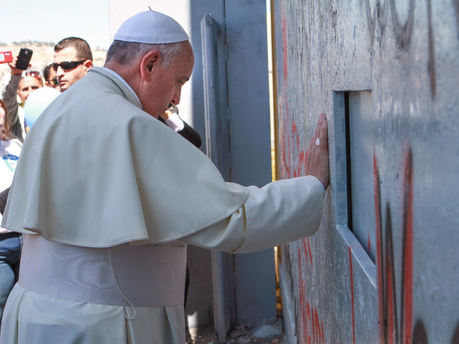 caption: Pope Francis prays at Israel's separation barrier on May 25, 2014 in the Occupied West Bank town of Bethlehem.