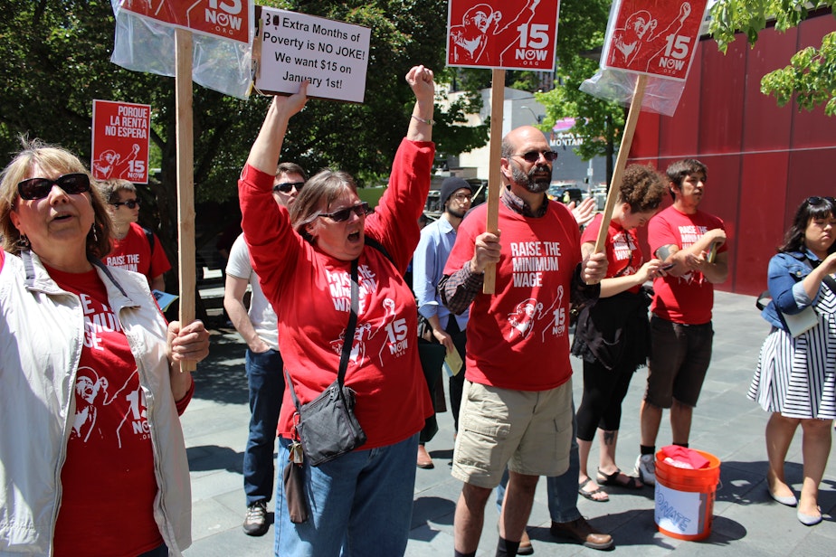 caption:  Linda Jansen and Doug Nielson rallying for $15 minimum wage outside City Hall on Monday. The Seattle City Council voted to pass the minimum wage bill unanimously.