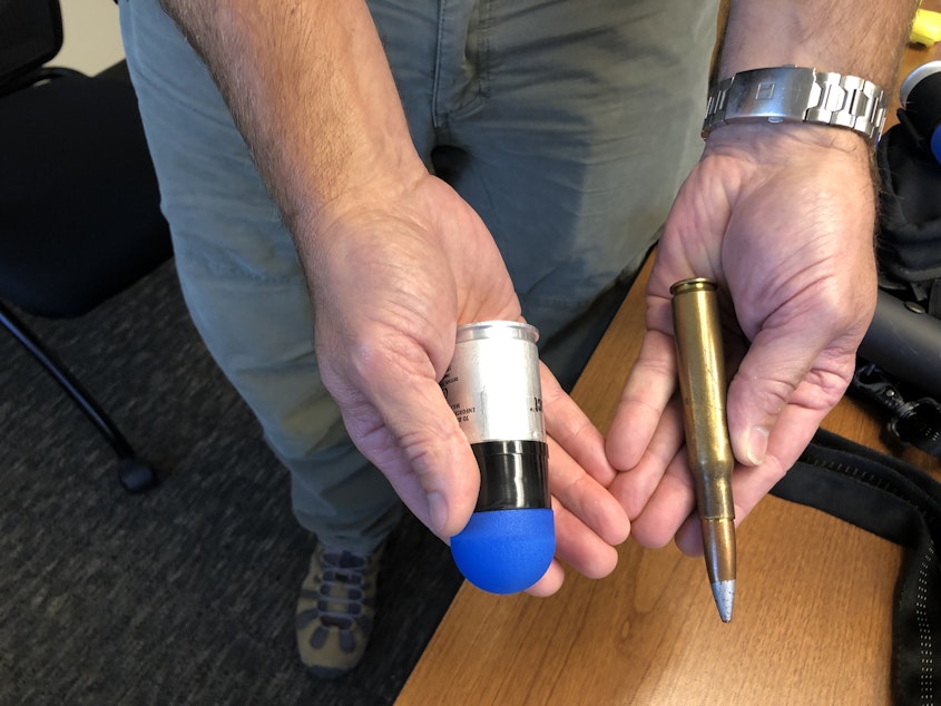 caption: On the right, the type of .50 caliber military round banned by HB 1054. On the left, the 40mm sponge-tipped less-lethal round also covered by the ban. 