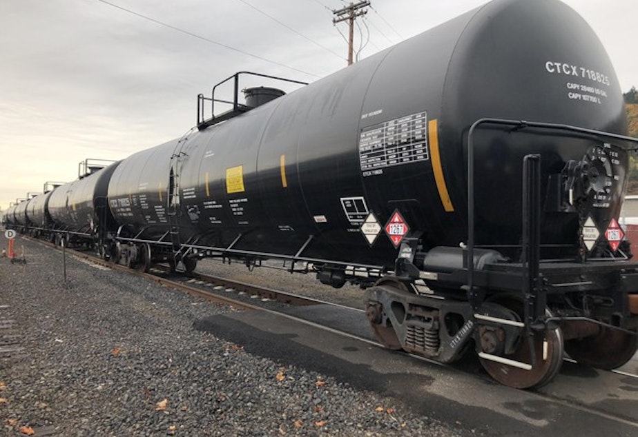 caption: <p>Trains containing petroleum crude oil on a rail line outside of Zenith Terminals, sandwiched between the Willamette River and Forest Park in Portland's northwest industrial district.</p>