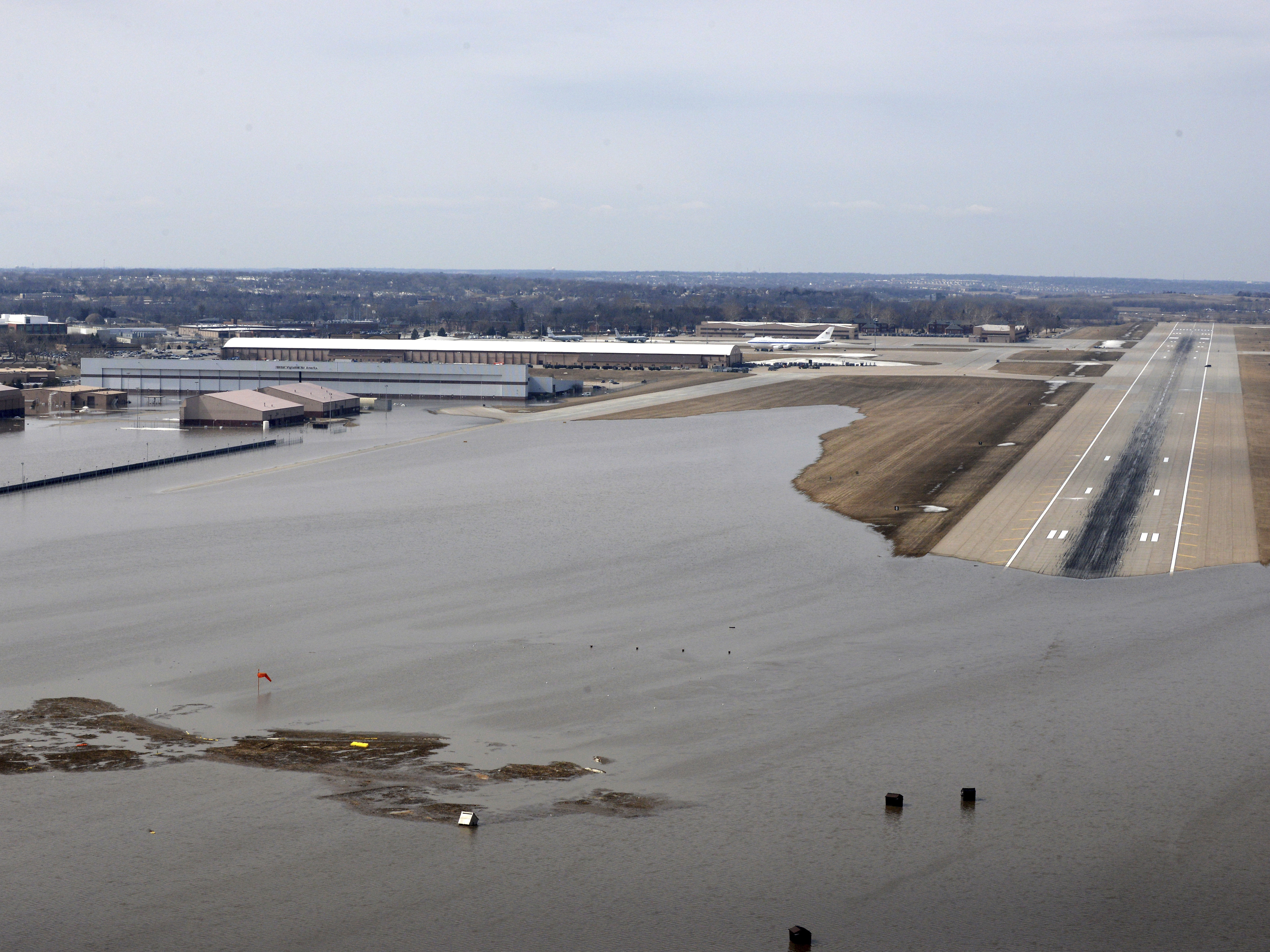 caption: An aerial view of Offutt Air Force Base and the surrounding areas affected by floodwaters in Nebraska on March 17. One-third of the base was covered by water from flooding.