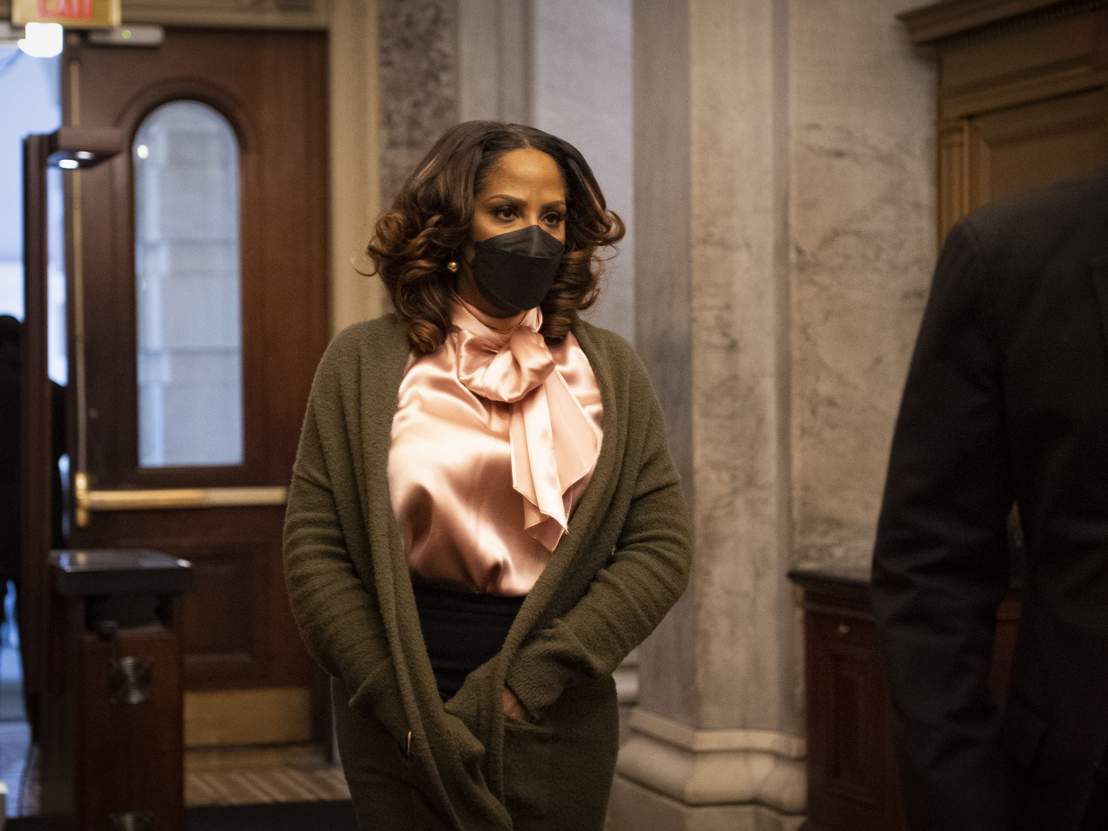 caption: Impeachment manager Del. Stacey Plaskett, D-V.I., walks through the first floor of the Senate during a break in the Senate impeachment trial.