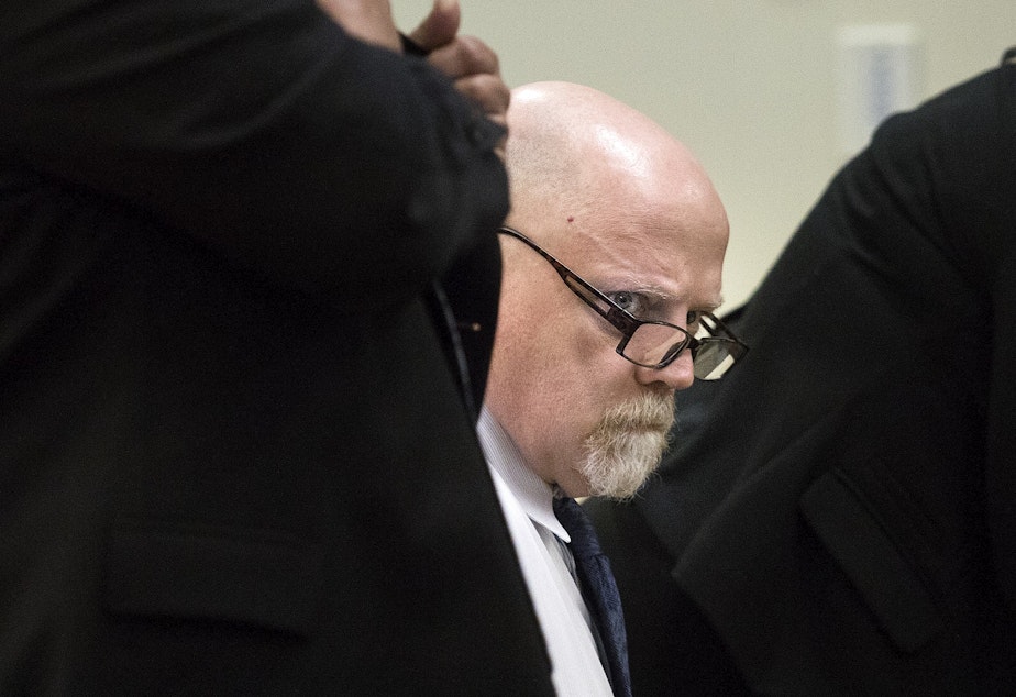 caption: William Talbott II looks around the courtroom during the first day of jury selection in his trial. He is accused of the 1987 murders of Tanya van Cuylenborg and Jay Cook.