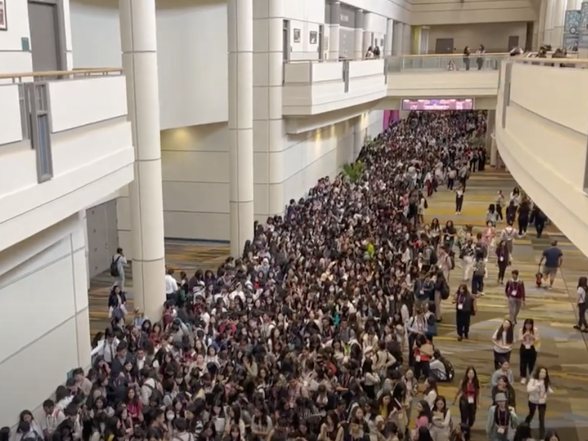 caption: Tech workers said they saw unusually high numbers of men in a monster line for a career expo at a tech conference aimed at elevating women and nonbinary workers.