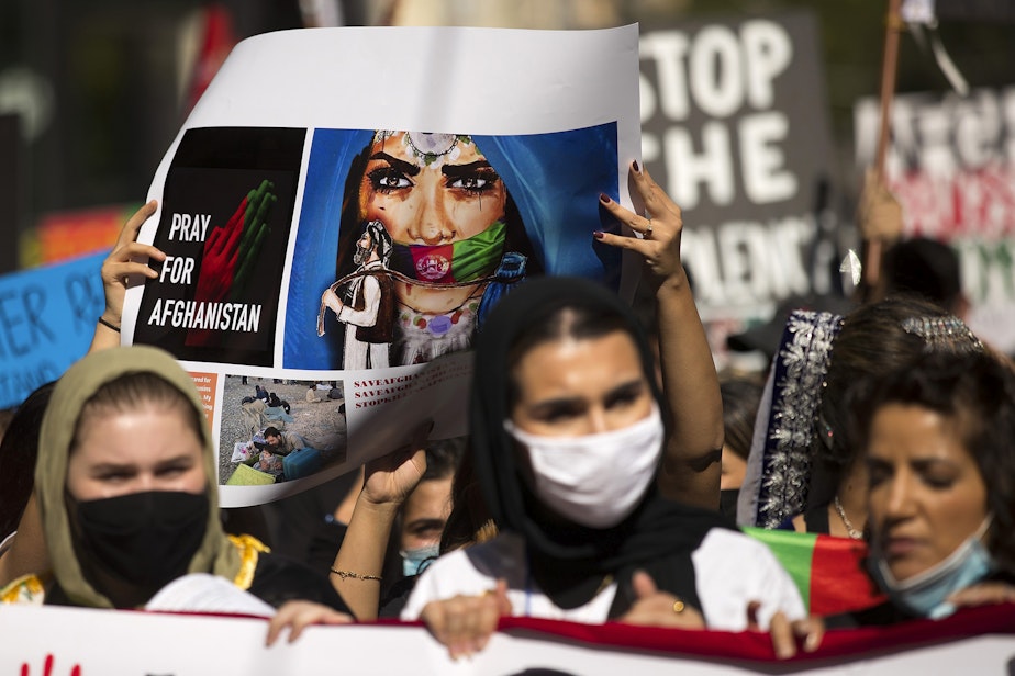 caption: About 100 people attended a rally and march organized by Afghans of Seattle, a new organization composed of young Afghan-Americans in the greater Seattle area, to stand in solidarity with Afghans on Saturday, August 28, 2021, at Westlake Park in Seattle.