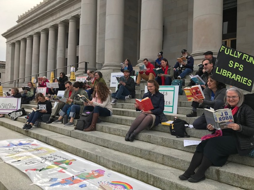 caption: Seattle Public Schools librarians held a "read-in" on the state capitol steps in Olympia on Tue., April 2, 2019 to call for a lift of the levy lid and more funding for schools.