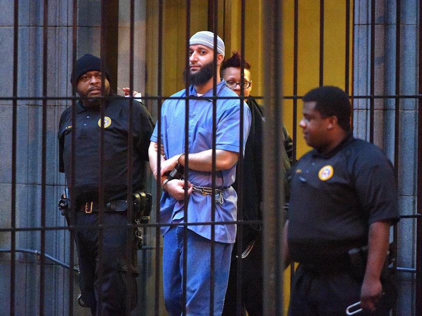 caption: Officials escort convicted killer Adnan Syed, subject of the <em>Serial</em> podcast, from a courthouse in Baltimore in February 2016.