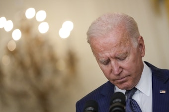 caption: President Biden bows his head in a moment of silence Thursday as he speaks about the situation in Afghanistan from the White House's East Room.