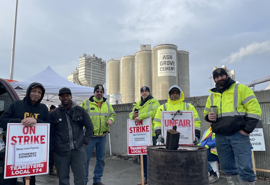 caption: Teamsters union members demonstrating outside the Ash Grove Cement plant and Stoneway Concrete yard on East Marginal Way South near the West Seattle Bridge entrance. They were tired -- been striking since November -- but committed to seeing it through and fully believe in their cause. Tim Davis is second from left, and Ron Hills is third from left.