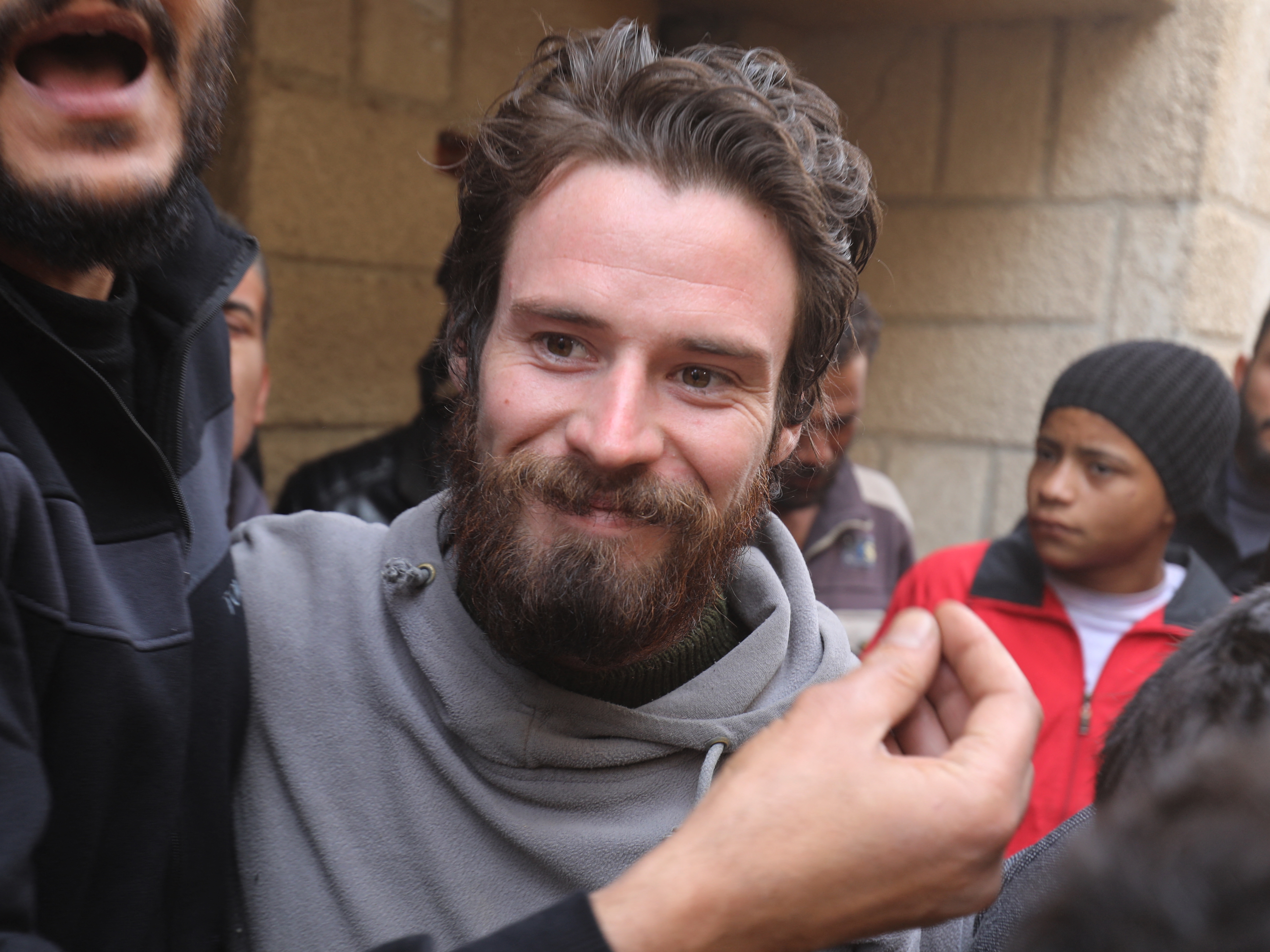 caption: Travis Timmerman, a U.S. citizen who had entered Syria from Lebanon on a Christian pilgrimage and had been detained for several months, speaks with reporters in Damascus on Thursday, after he was found in the village of Thihabiyeh east of the capital following the fall of longtime Syrian President Bashar al-Assad.