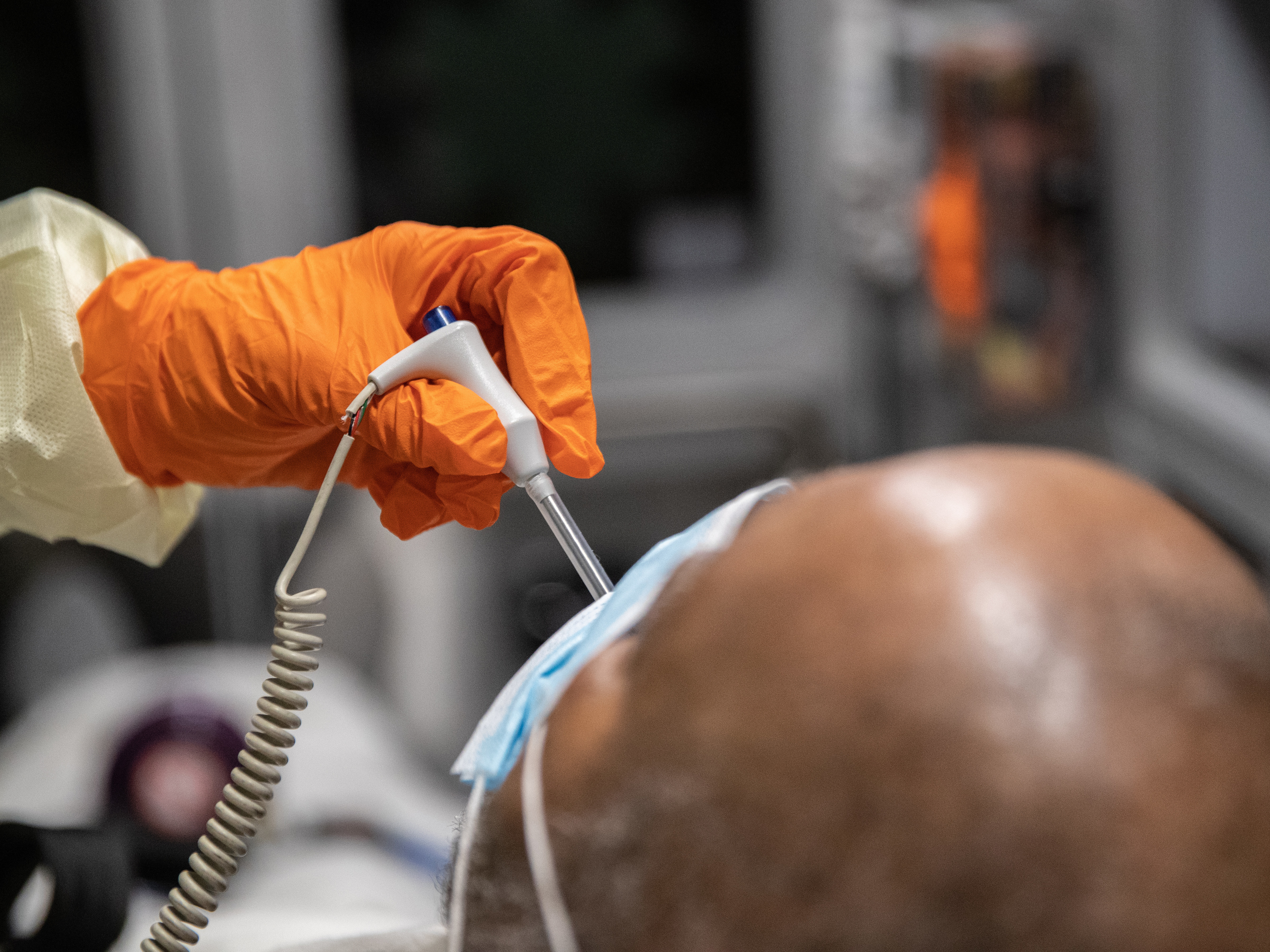caption: A hospital patient in Stamford, Conn., who has COVID-19 symptoms gets his temperature checked. Severe infections with the novel coronavirus have been unusually high among African Americans and Latinos in many hospitals.