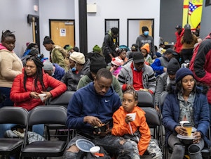 caption: Migrants eat a meal at the La Colaborativa day shelter in Chelsea, Massachusetts, on February 22, 2024. The shelter opened on February 20, and helps migrants, mainly from Haiti, build resumes, get work, receive health care. 