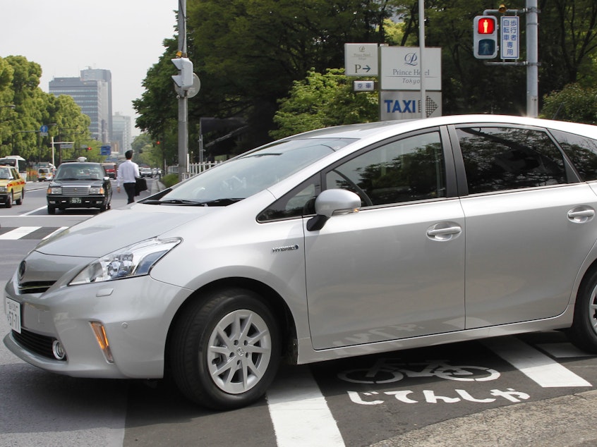 caption: Toyota says it will use a software update to fix an issue with some Prius models, saying certain conditions could result in their unexpectedly stalling. Here, a Prius is seen during a test drive in Tokyo in 2011.