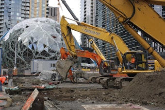 caption: Excavation equipment has just begun digging for the next phase of Amazon's headquarters.