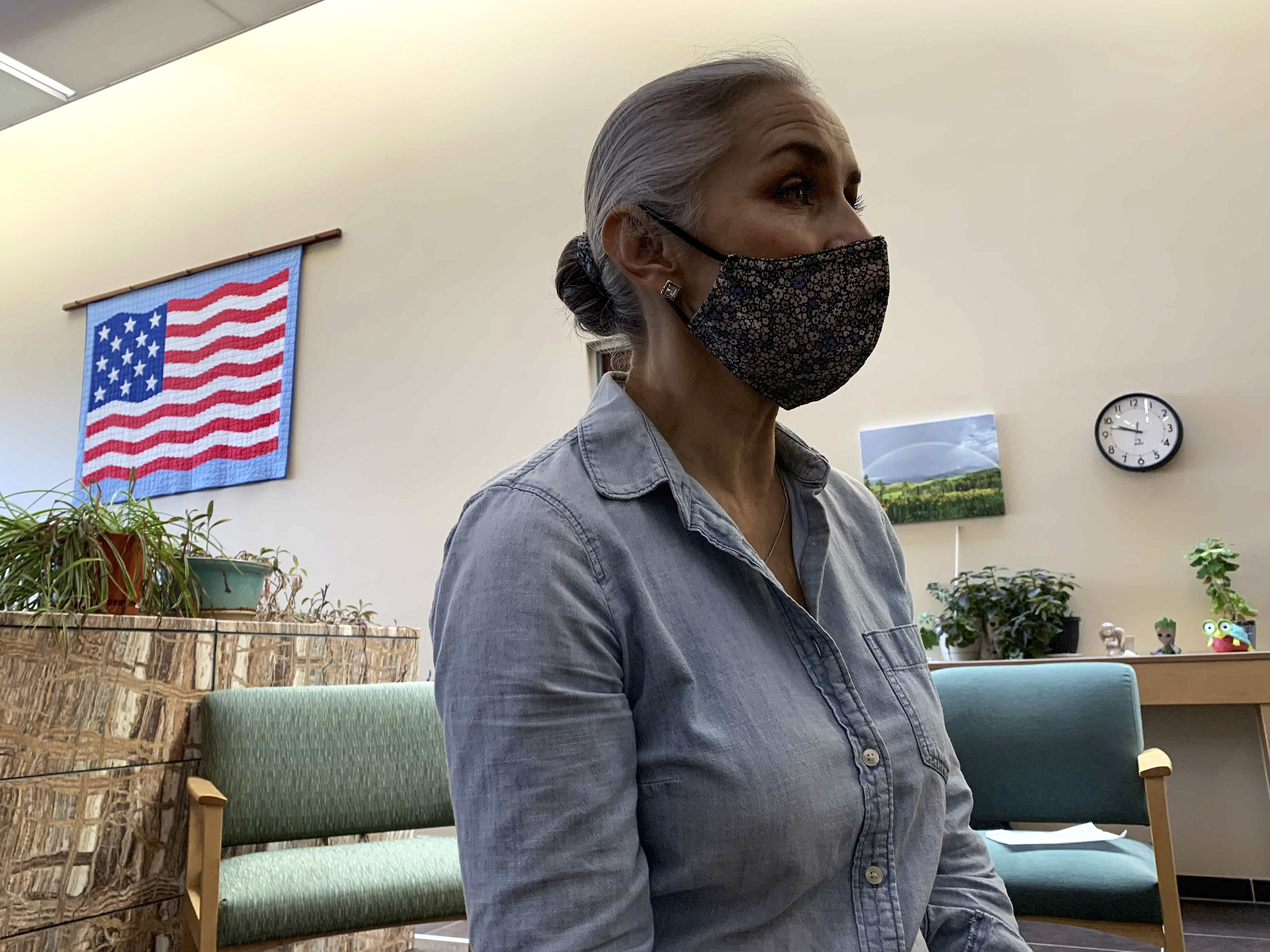 caption: Christina Campos, administrator of the Guadalupe County Hospital, says the community has been hit with several large outbreaks of the virus, most recently in May, which has bolstered vaccination rates.