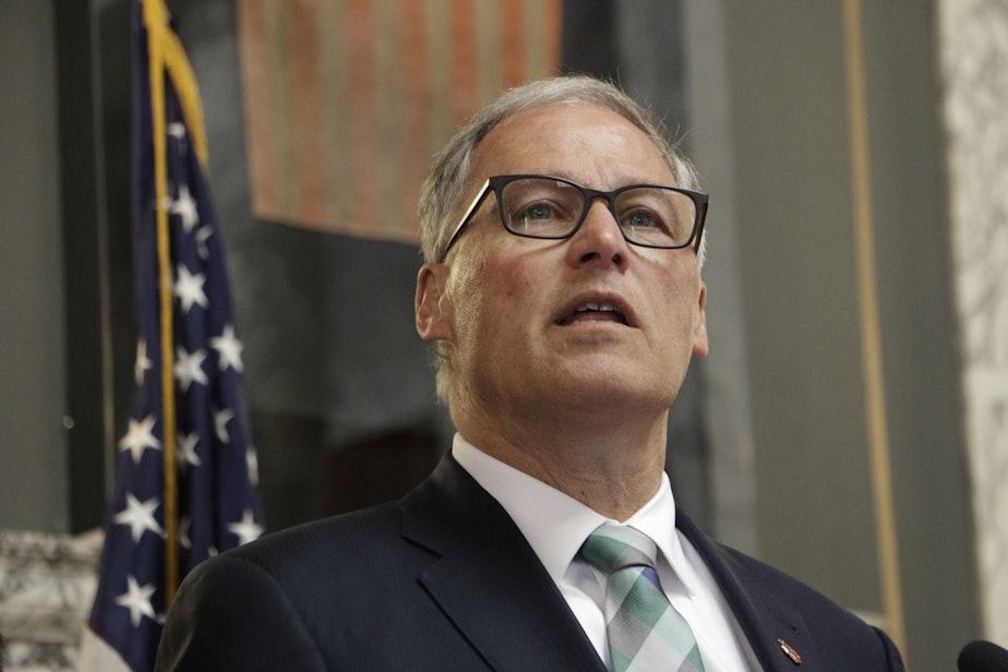 caption: Washington Gov. Jay Inslee speaks before signing a measure that puts the state on track to create the first 'public option' health insurance in the US, Monday, May 13, 2019, in Olympia, Wash.