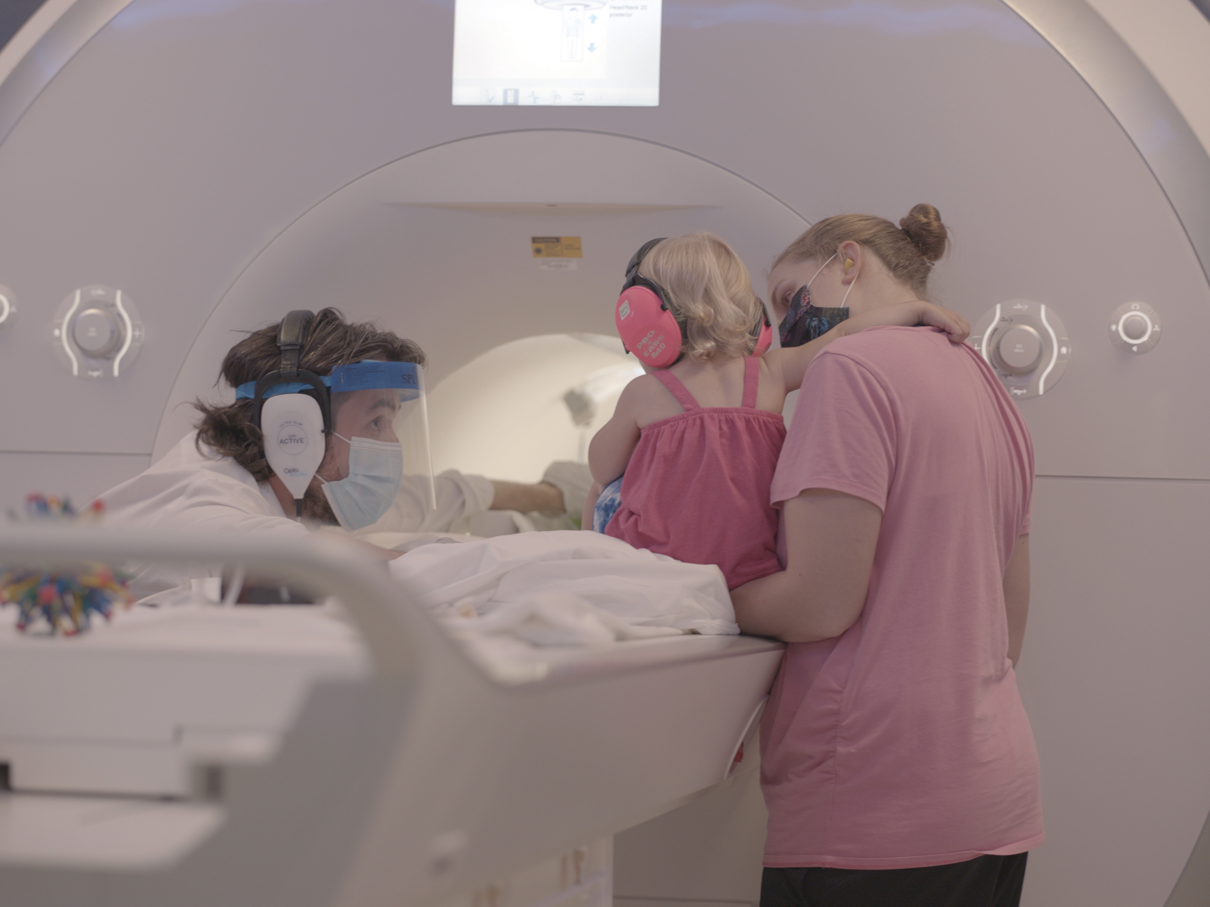 caption: Yale cognitive neuroscientist Nick Turk-Browne works with a baby and parent during a brain scan.