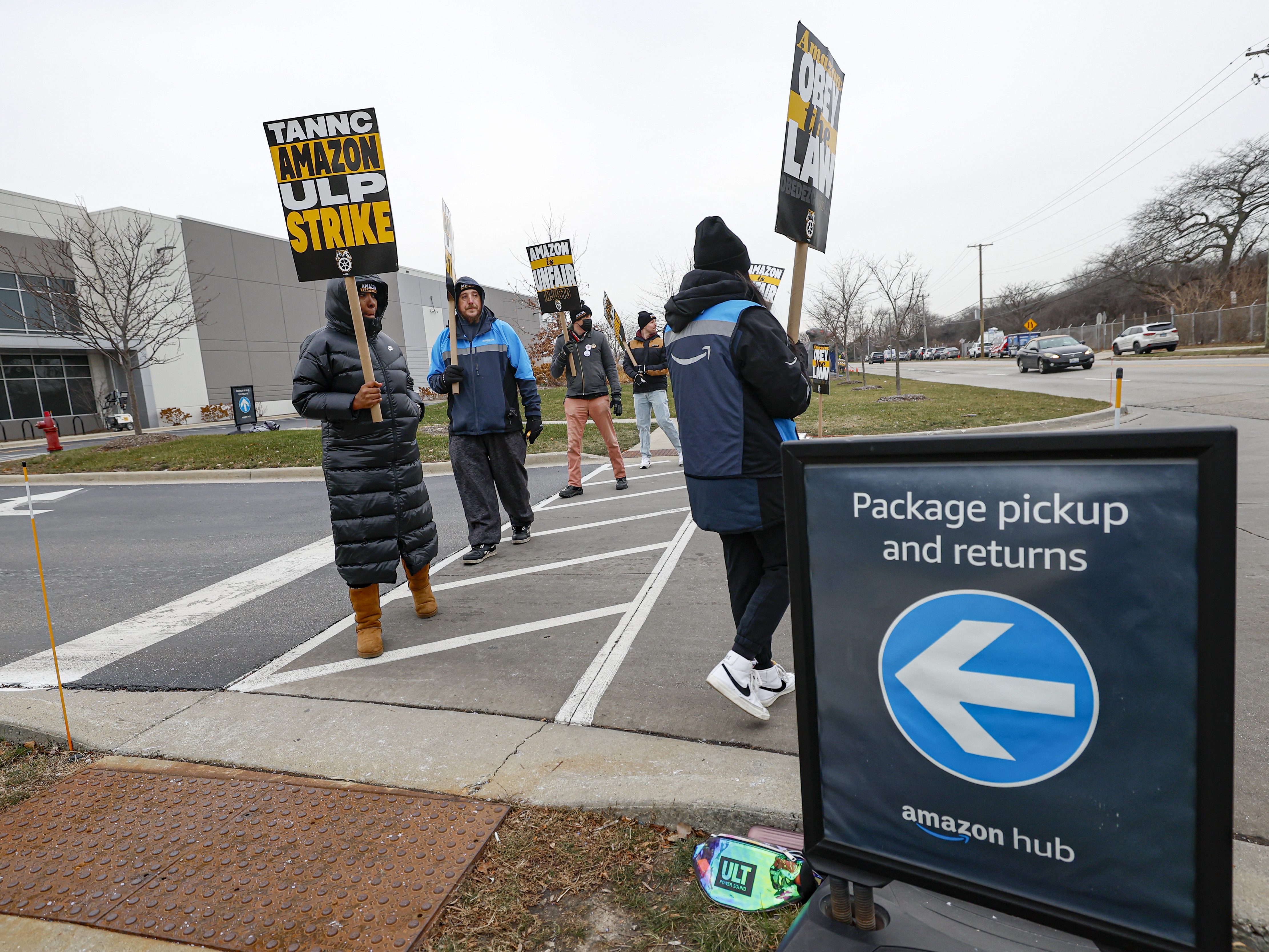 caption: Amazon delivery drivers walk the picket line outside a delivery station as they went on strike in Skokie, Illinois on Thursday.