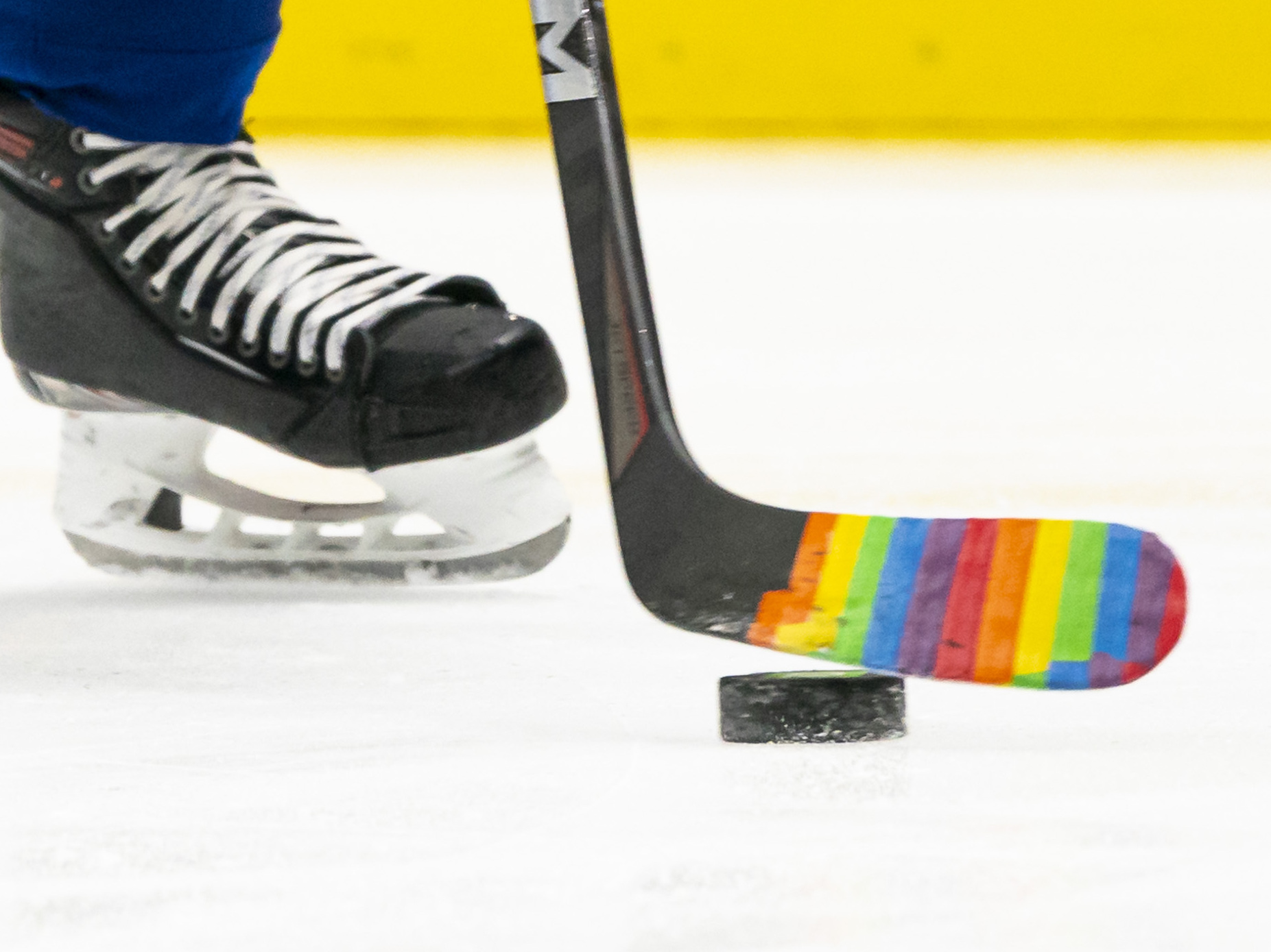 caption: Pride Tape was quickly adopted by NHL teams as a way to support and celebrate LGBTQ+ fans and athletes. But the NHL has banned the tape. Here, a player used the tape on their stick for a pre-game warm up to celebrate a "Hockey is for Everyone" night in March 2021.