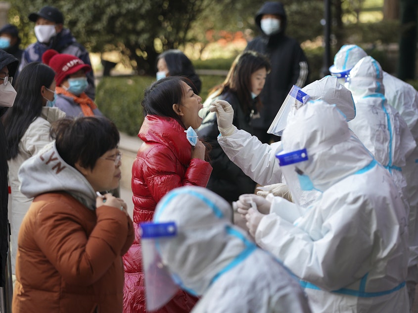 caption: In this photo released by Xinhua News Agency, medical workers take swabs from residents in Shijiazhuang in north China's Hebei province on Jan. 6. Authorities have announced new restrictions to contain the coronavirus.