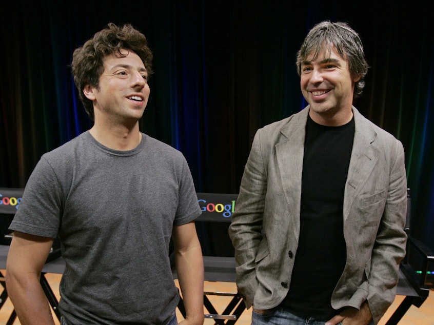 caption: Google co-founders Sergey Brin (left) and Larry Page announced Tuesday they are stepping down from their leadership roles but will remain board members of Alphabet, Google's parent company.