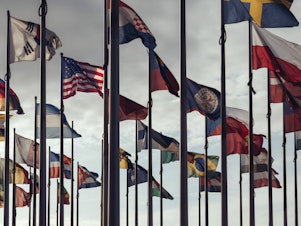 caption: Flags of different nations. The new Freedom House report finds that the gap between the number of countries where freedom has improved and where it has declined is at its narrowest in 17 years.
