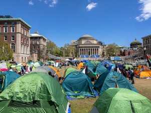 caption: Protesters seen in tents on Columbia University's campus on April 24. The school later suspended protesters who didn't leave, and called New York City police to arrest those who occupied a building on campus.