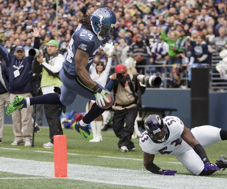 caption: Seattle running back Marshawn Lynch makes a run against the Baltimore Ravens at CenturyLink Field in 2011.