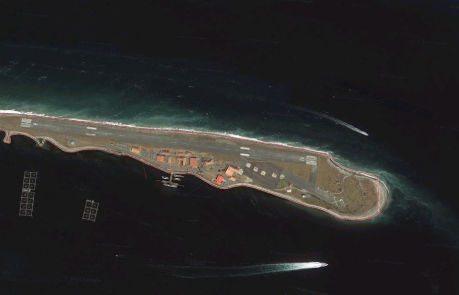 caption: Port Angeles' Ediz Hook, with Cooke's rectangular net-pen structures, housing about 700,000 Atlantic salmon, at lower left.