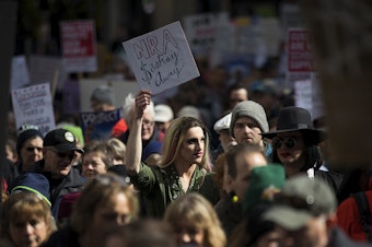 caption: Jesse Pettibone, 23, center, marches on Saturday, March 24, 2018, during March For Our Lives in Seattle. "Youth, queer people and people of color are often the victims of gun violence and we need to disarm that hate now," Pettibone said. 