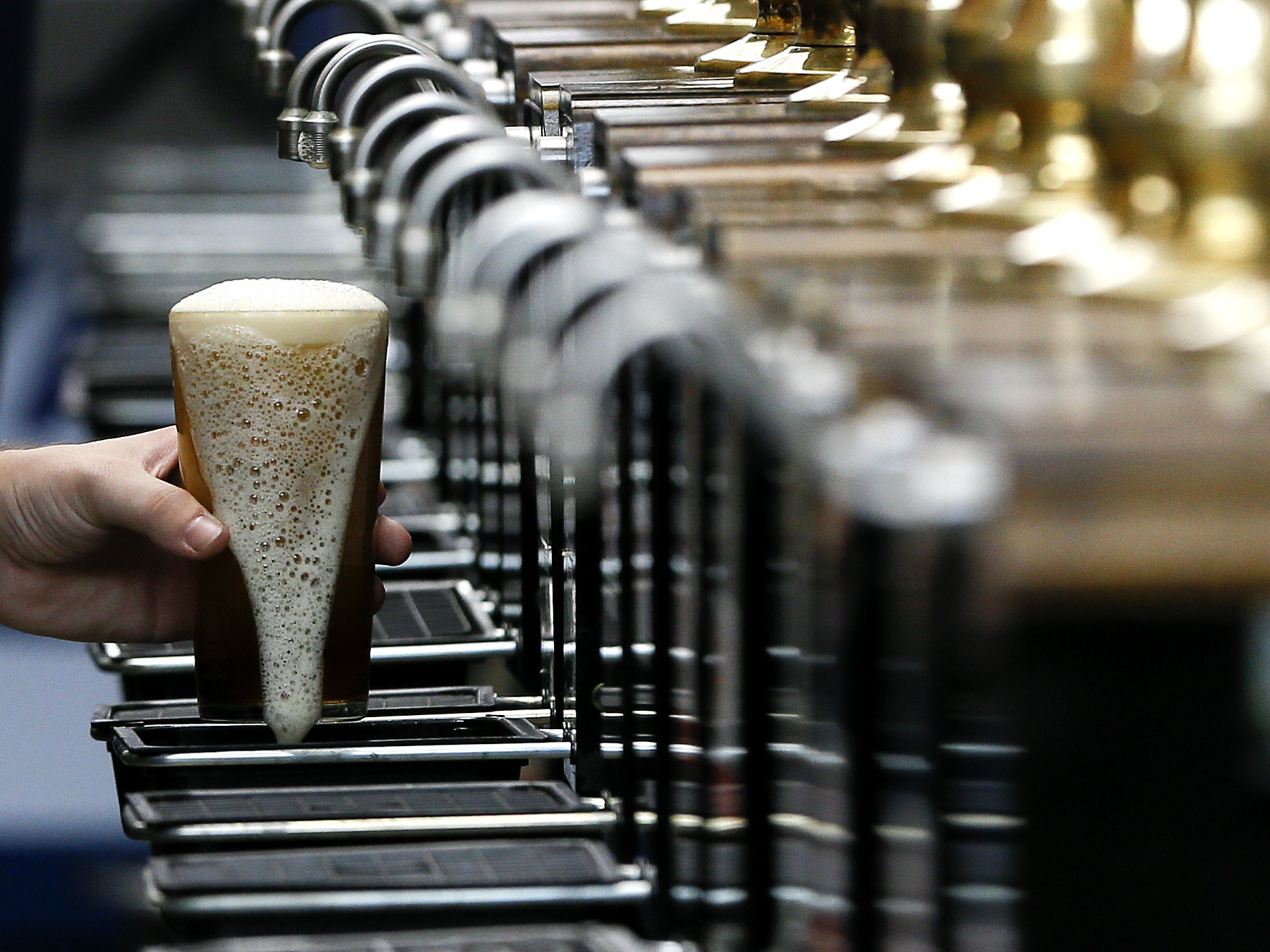 caption: A pint of beer is poured at the 2015 Great British Beer Festival in London. A brewery in the northeast of England is giving away beer to help raise money for the National Health Service during the coronavirus pandemic.
