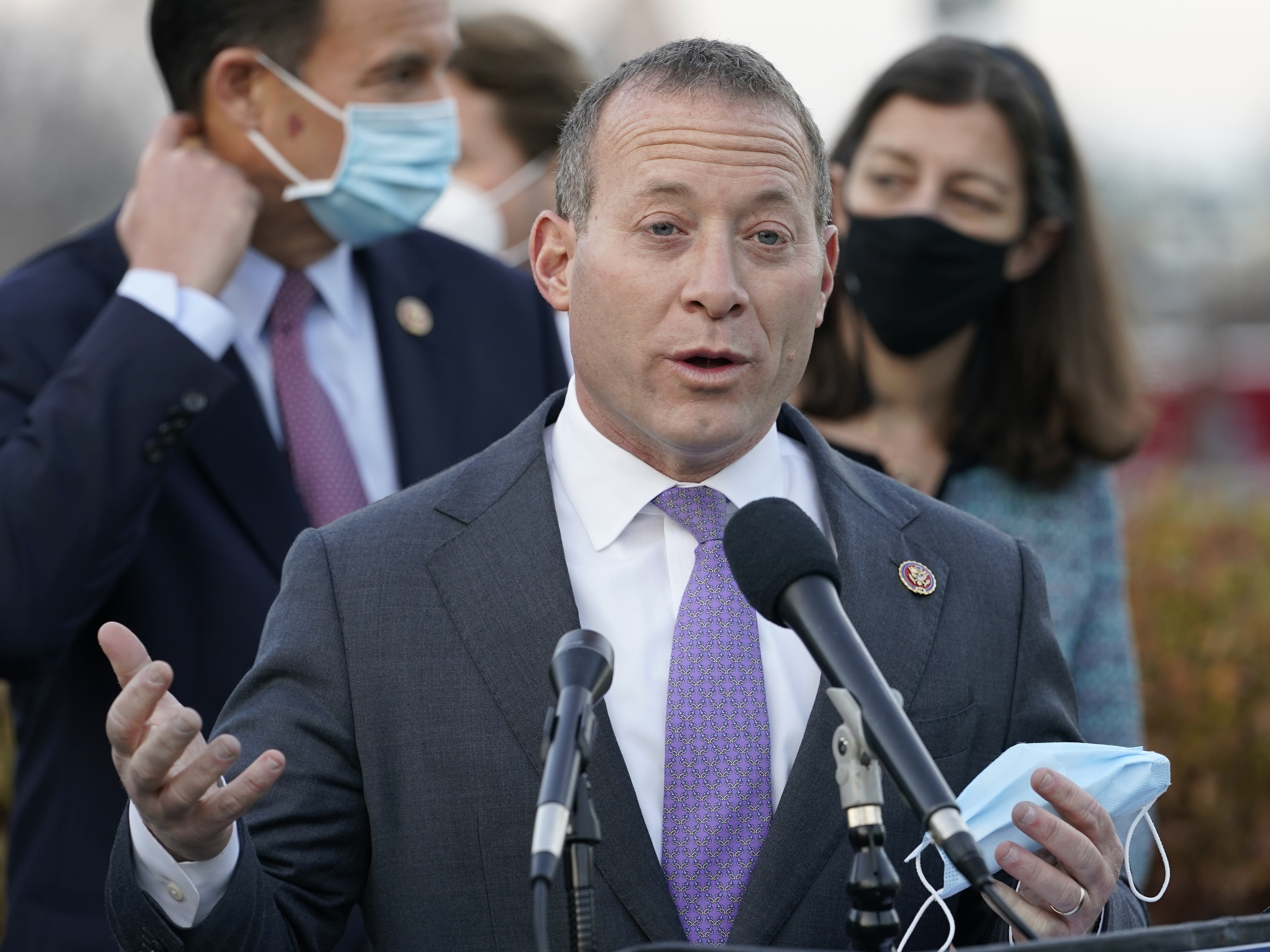 caption: Rep. Josh Gottheimer, D-N.J., seen here at a December news conference, is one of nine House Democrats threatening to withhold their support for a crucial budget resolution unless Speaker Nancy Pelosi first brings up a vote on the bipartisan infrastructure bill.