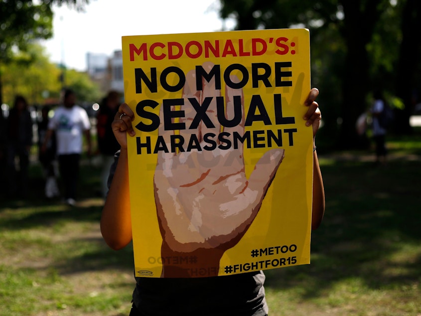 caption: A McDonald's employee holds a sign during a protest against sexual harassment in the workplace in Chicago, on Sept. 18, 2018.