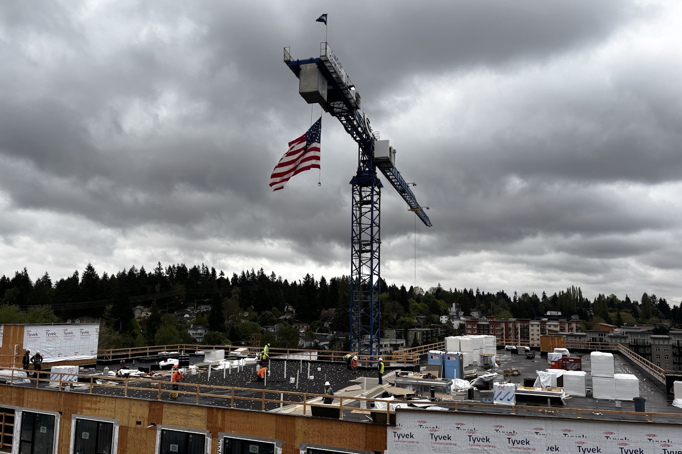 caption: A crane above a residential midrise building at Northgate.