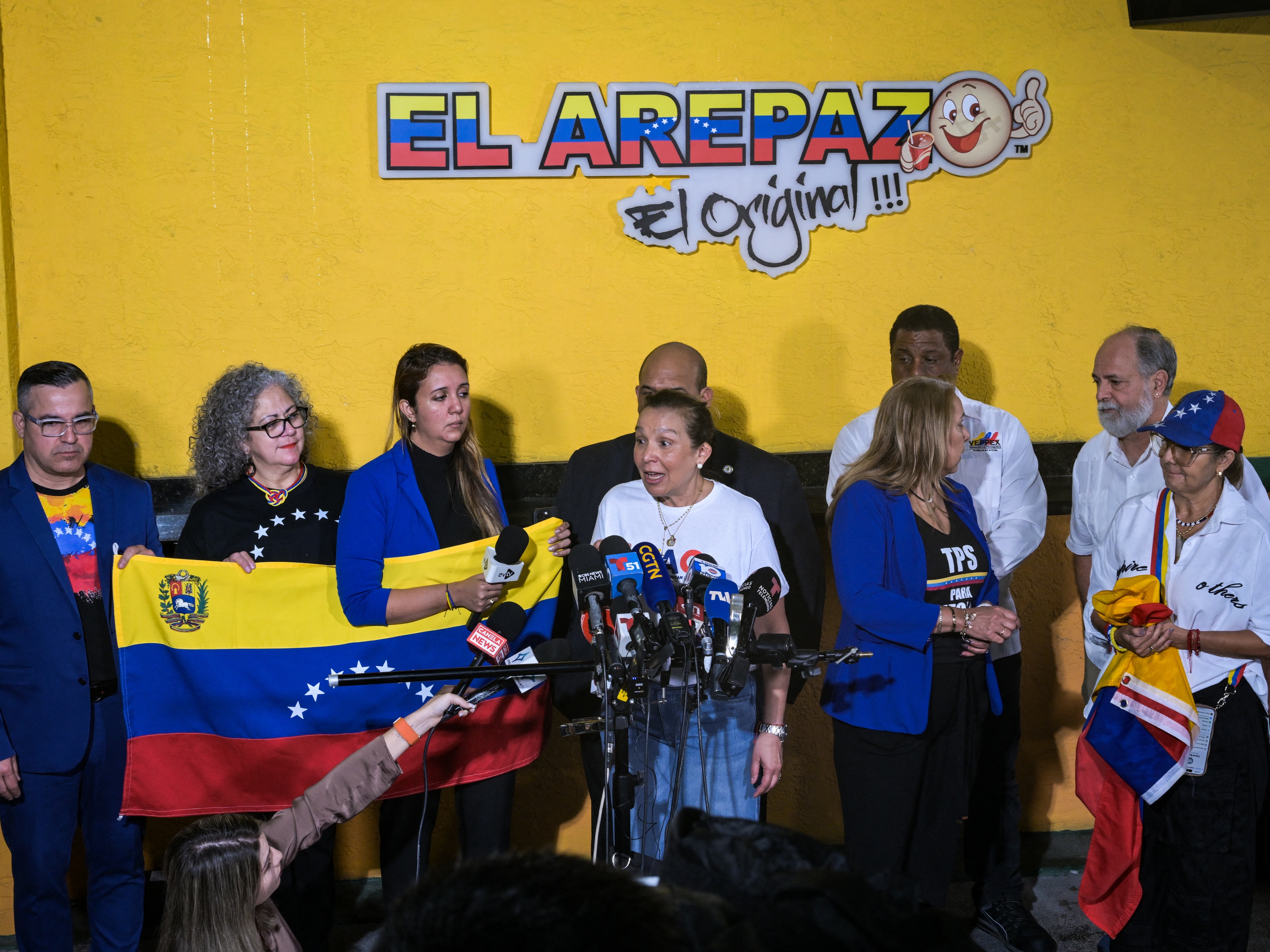 caption: Venezuelan community leaders speak to the media as they protest against the suspension of Temporary Protected Status in Doral, Florida, on Monday. The Trump administration is terminating an immigration program that currently protects hundreds of thousands of Venezuelan migrants in the U.S. from deportation.