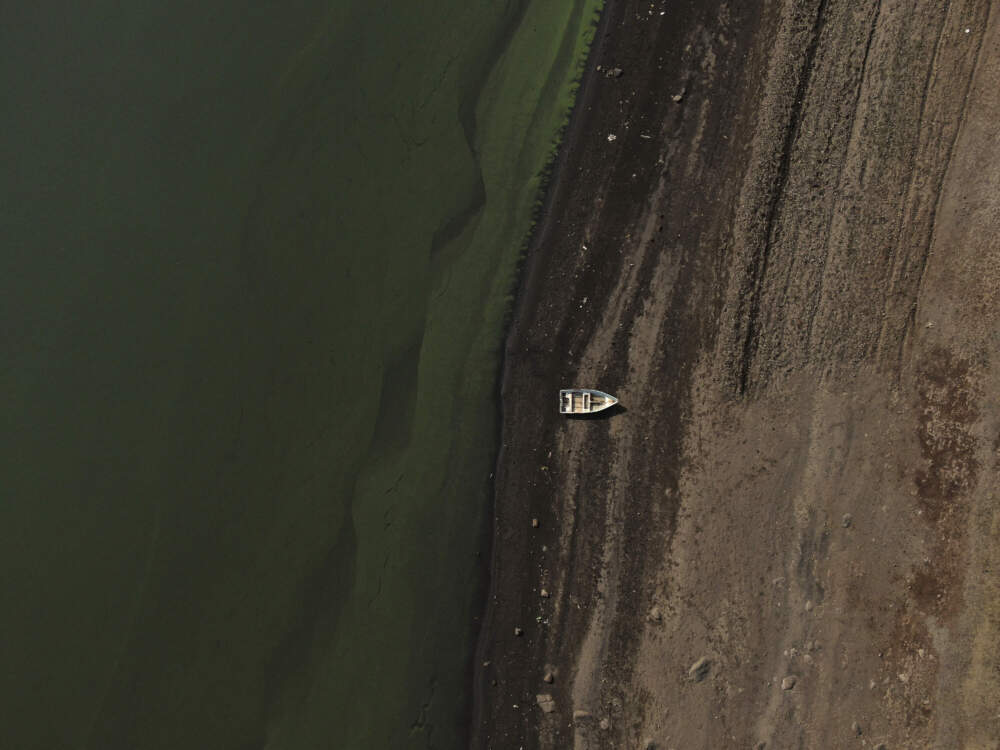 caption: A boat sits idle on the banks of Villa Victoria Dam, the main water supply for Mexico City residents. (Fernando Llano/AP)