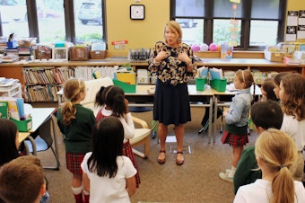 caption: Dr. Tammy Fisher, counselor at St. Thomas School in Medina, leads a second grade class in an exercise meant to teach them social-emotional skills. 