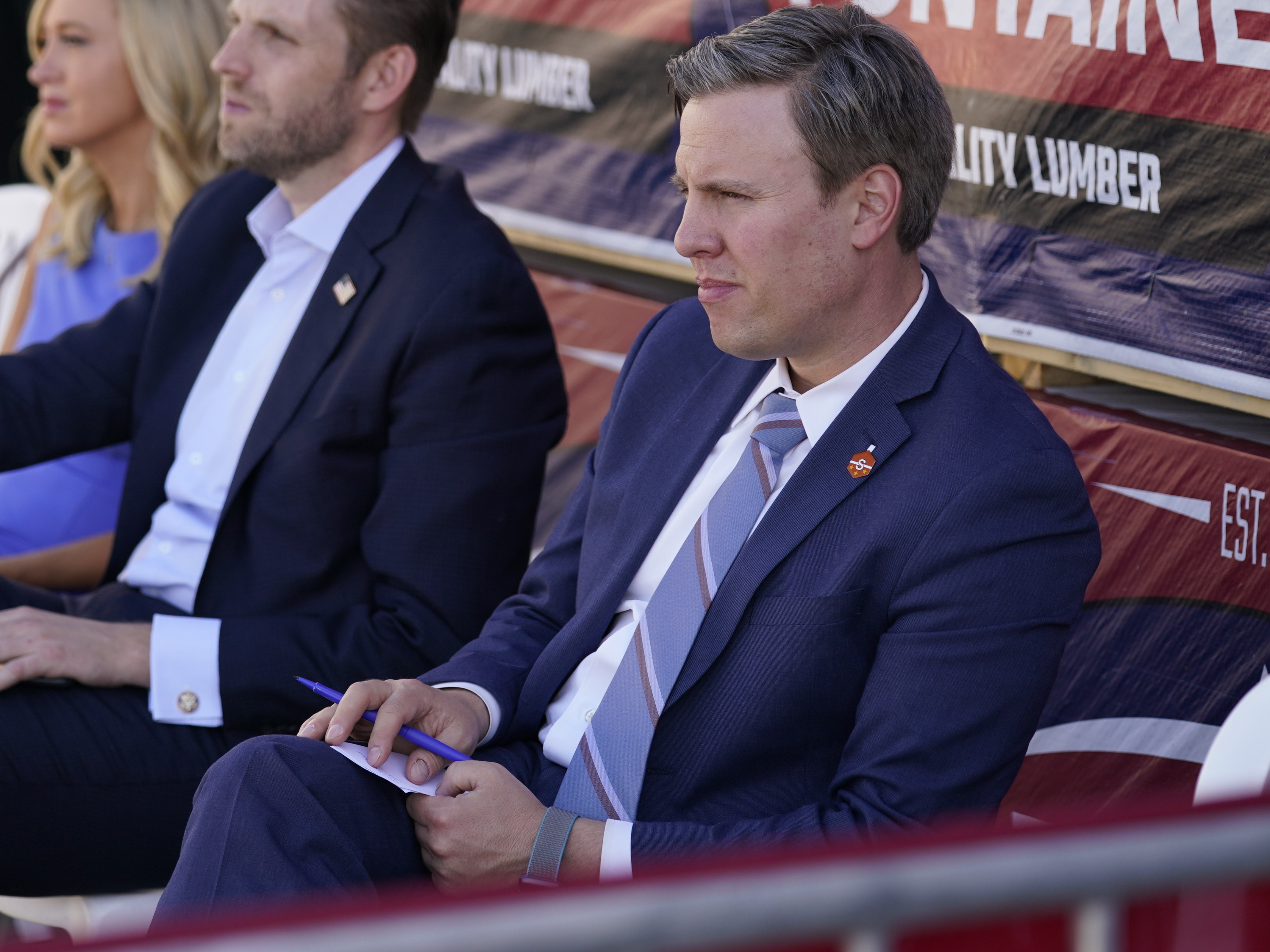 caption: President Donald Trump's 2020 campaign manager Bill Stepien listens as Trump speaks to a crowd of supporters during a campaign stop in Pa., on Aug. 20.