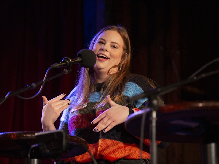 caption: Elizabeth Filipovich plays <em>Ask Me Another</em>'s final round at the Bell House in Brooklyn, New York.