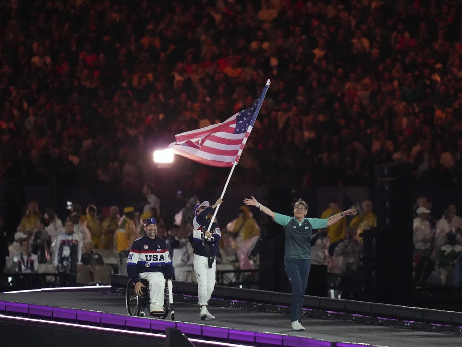 caption: Members of the United States delegation parade Sunday during the closing ceremony of the 2024 Paralympics in Paris