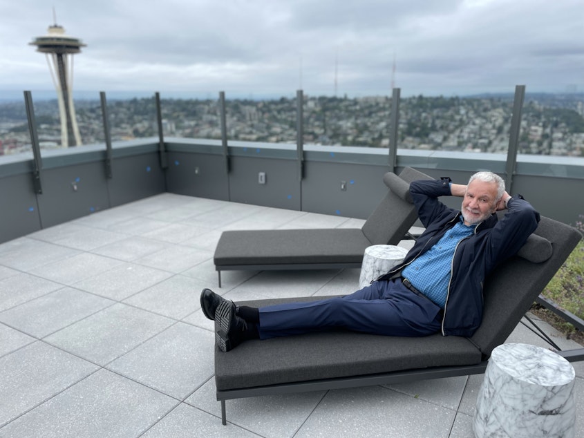 caption: Paul Menzies strikes a pose for a portrait on the roof deck of the Spire.