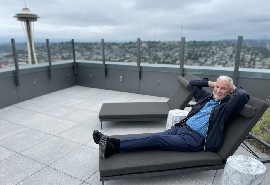 caption: Paul Menzies strikes a pose for a portrait on the roof deck of the Spire.